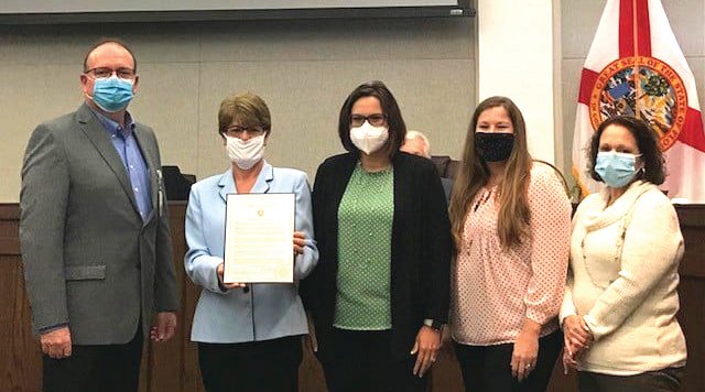 OKEECHOBEE – At their Nov. 12 meeting, the Okeechobee County Commission declared Nov. 19, as Rural Health Day in Okeechobee County. Left to right are Brian Melear, CEO of Raulerson Hospital, Commissioner Kelly Owens, Dr. Christine Bishop, Brennan Eye Care, Jenny Pung, Public Relations and Communications at Raulerson Hospital, and Tiffany Collins, health officer of the Florida Department of Health in Okeechobee.